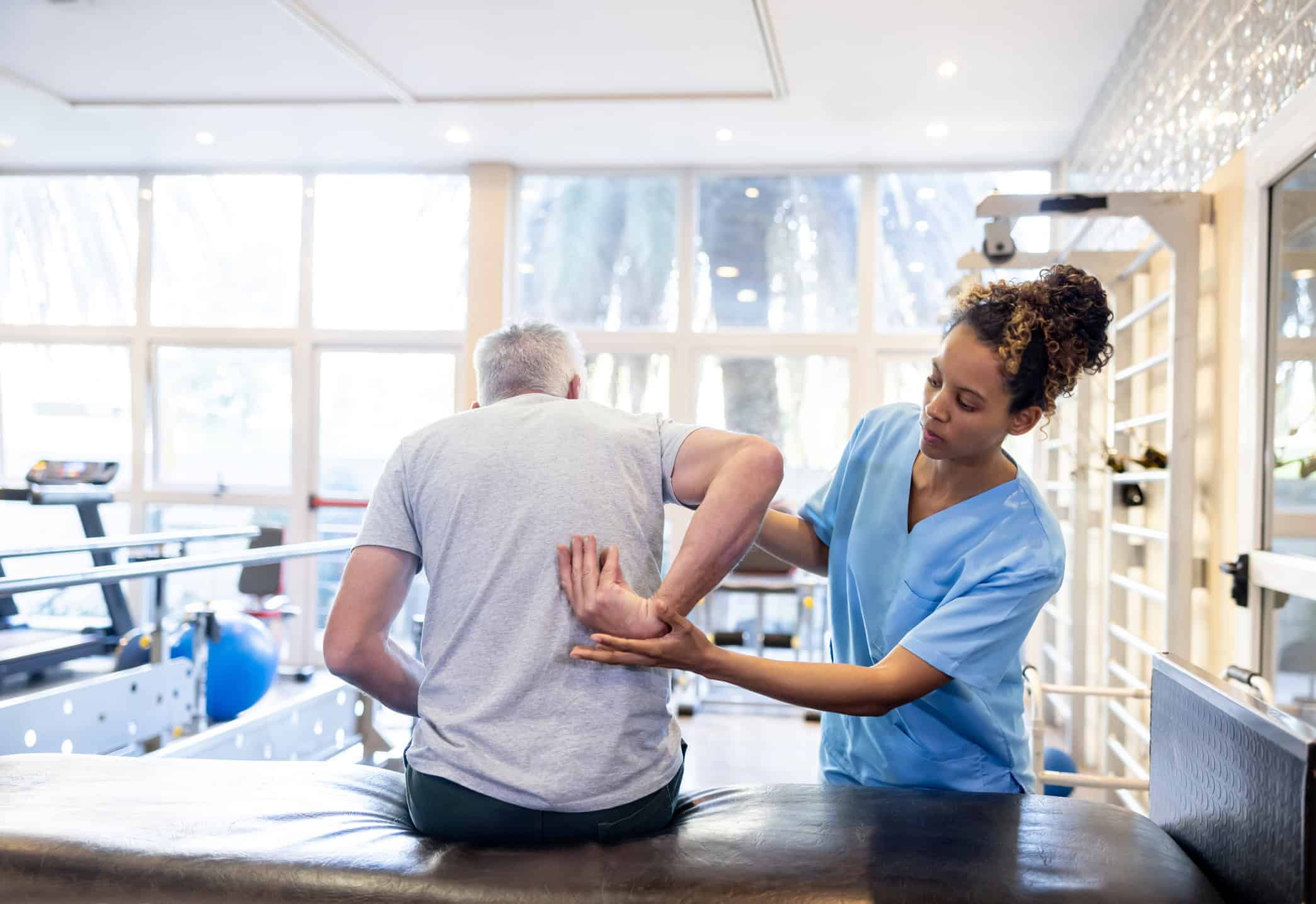 Licensed physical therapist performing manual therapy for lower back pain at Trinity Rehab