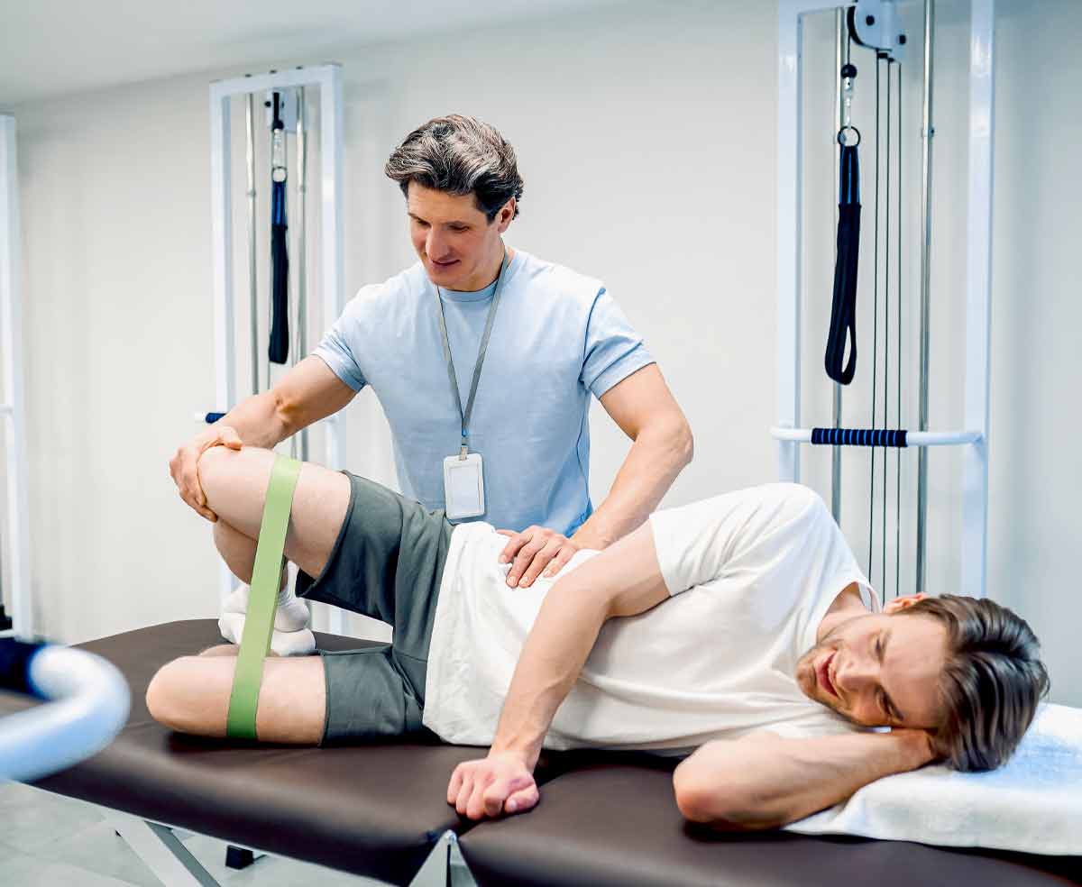 Patient performing knee rehabilitation exercises with physical therapist guidance