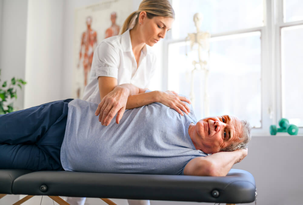 Physical therapist examining a patient with rotator cuff injury