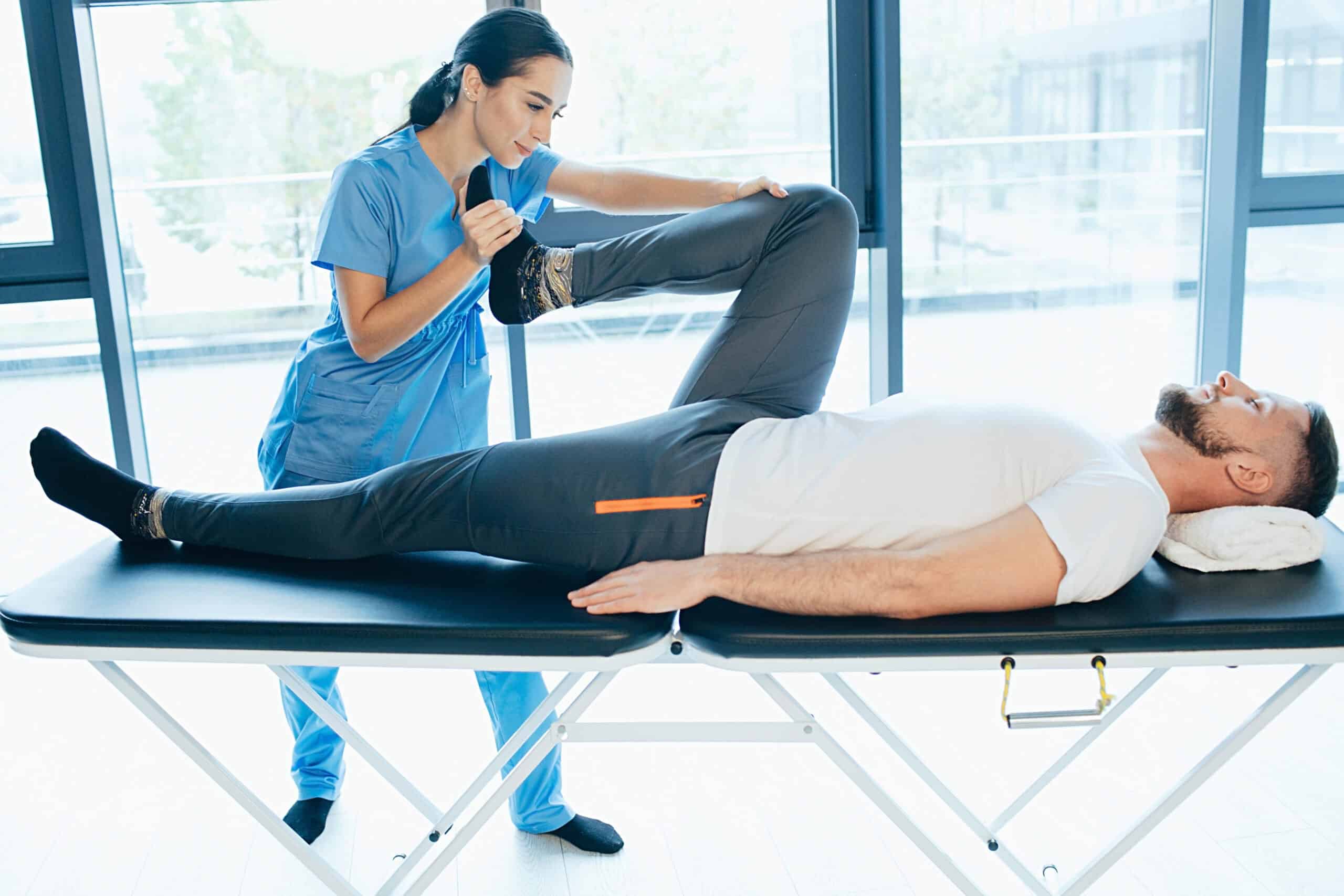 Therapist performing a hip mobility assessment